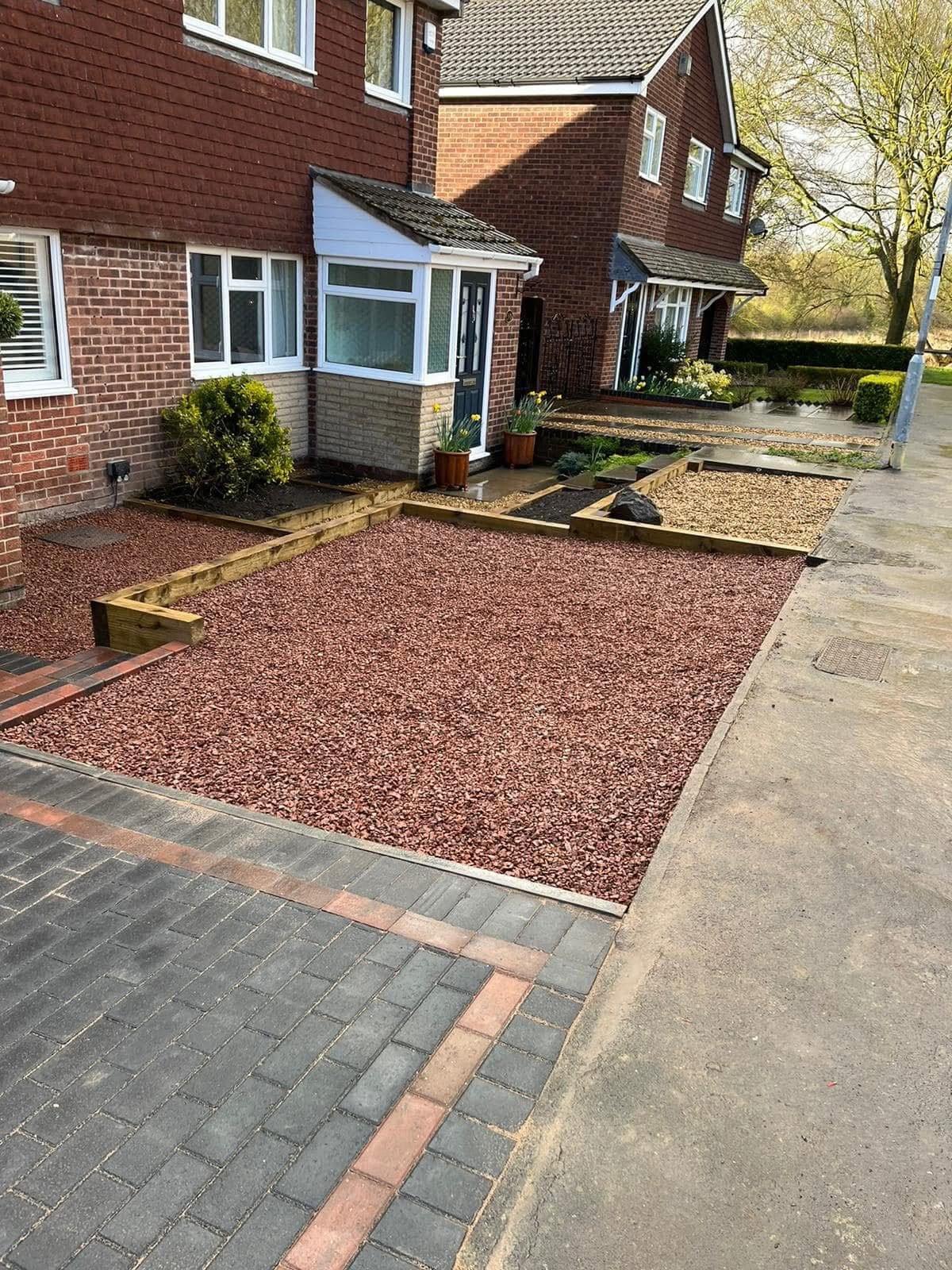 Finished front garden with red gravel, timber sleeper edging and block paving